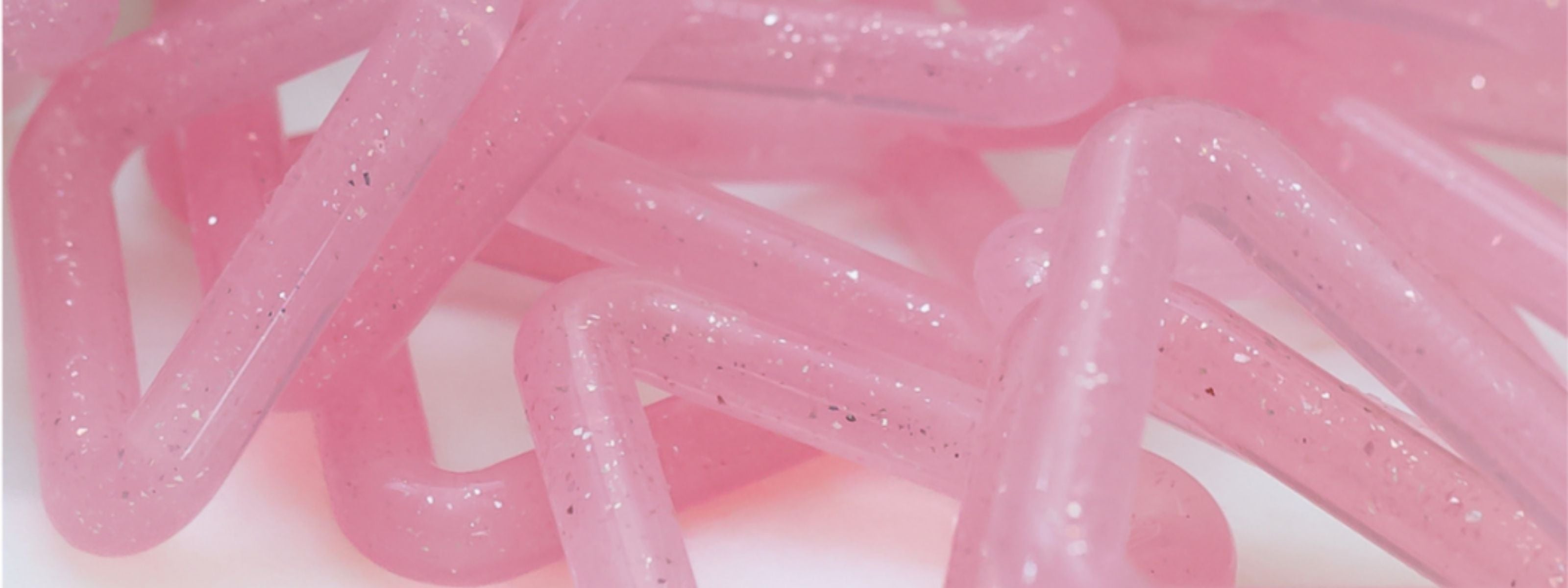 Triangle and Butterfly tools on a white surface — doctor-designed resistance devices strengthening facial and airway muscles for lift, jaw relief, and support during menopause.